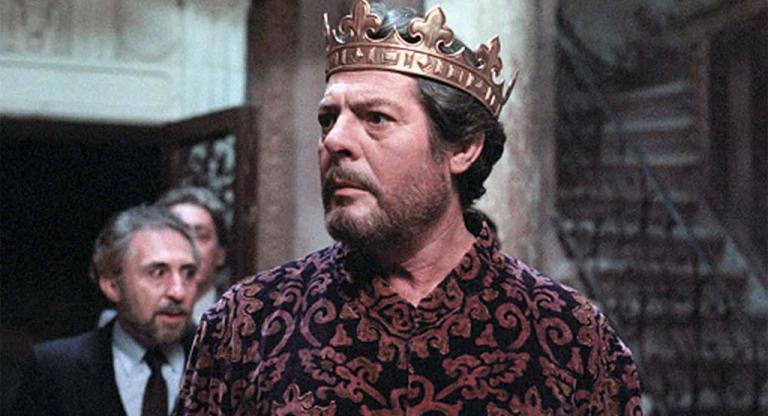 Marcello Mastroianni wears a crown.