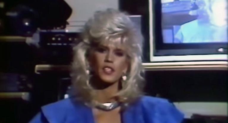 Porn star Amber Lynn sits in front of a TV monitor